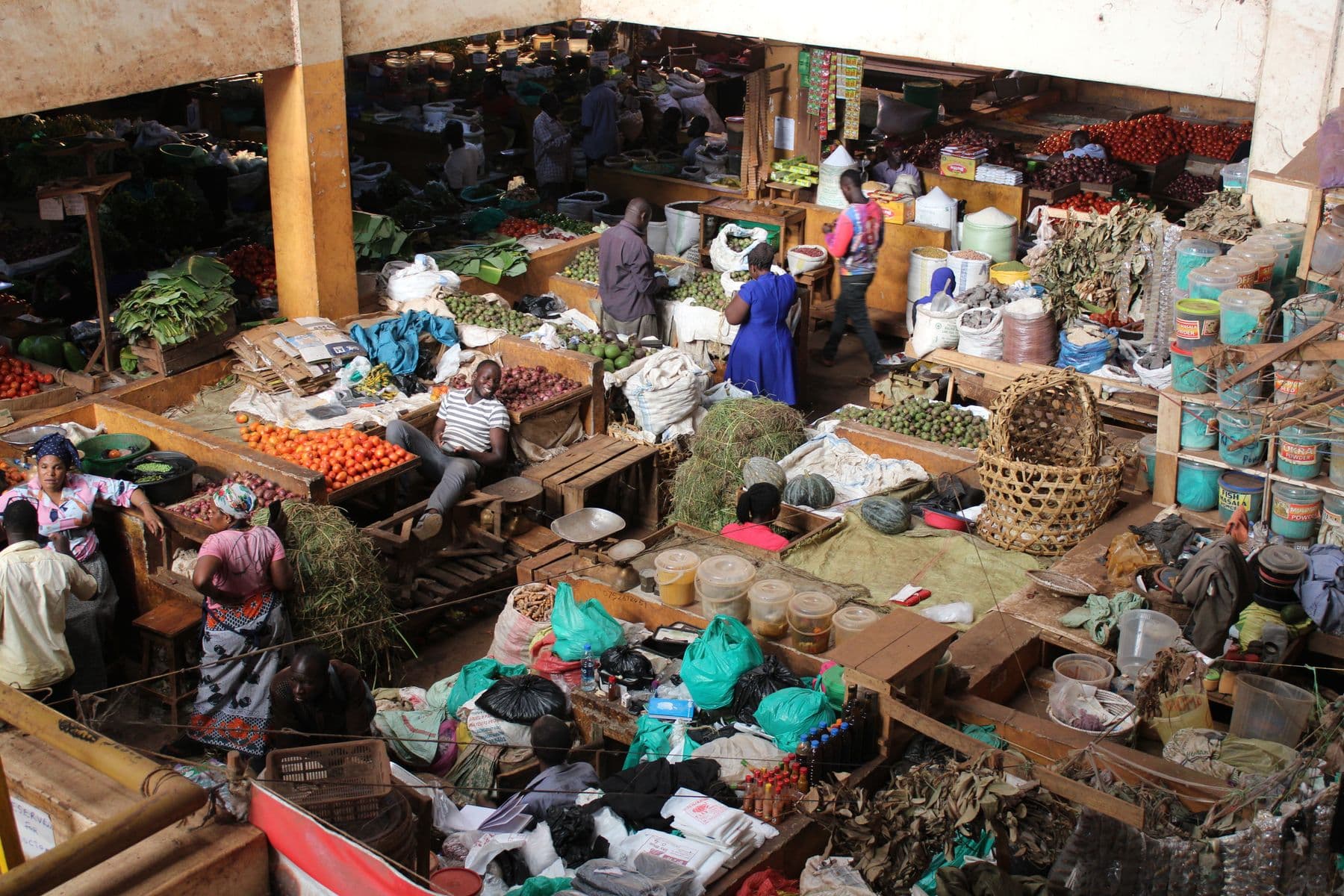 Traders and produce stalls filling a busy East African market